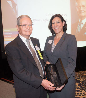 Cliff DeMars (pictured left), a 55-year volunteer in the credit union system, was recognized April 4 with the Virginia Credit Union League's highest individual honor, the James P. Kirsch Lifetime Achievement Award. Presenting the award is Virginia Credit Union League Chairman Suzanne Hodgins.